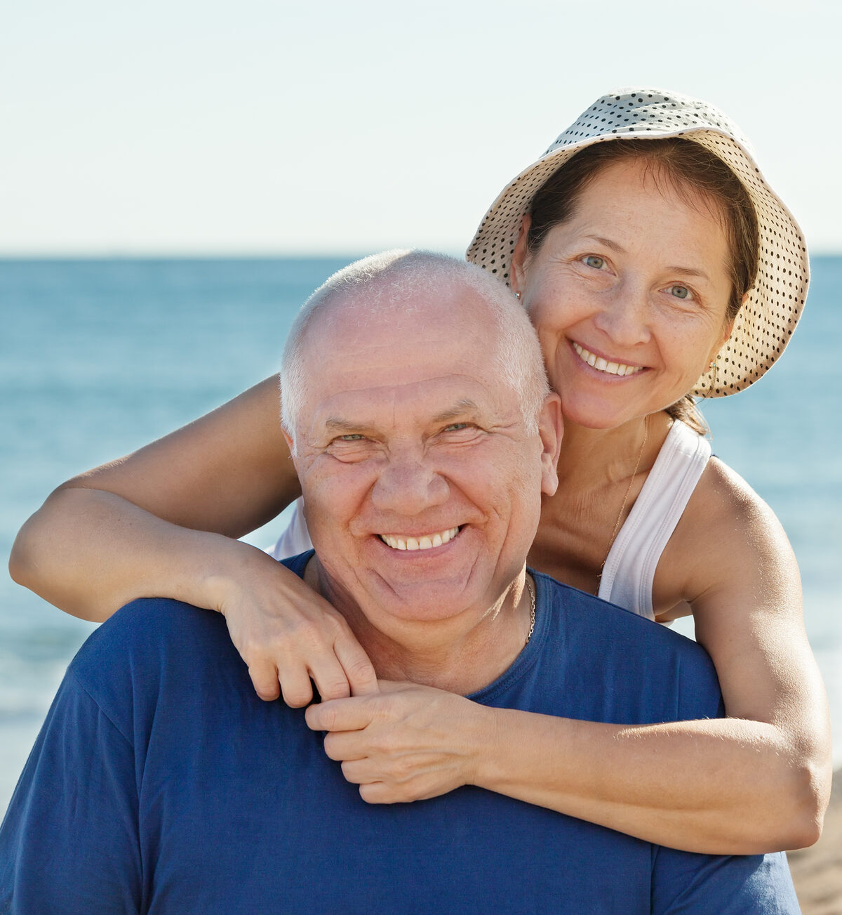 A smiling older couple enjoying time together outdoors
